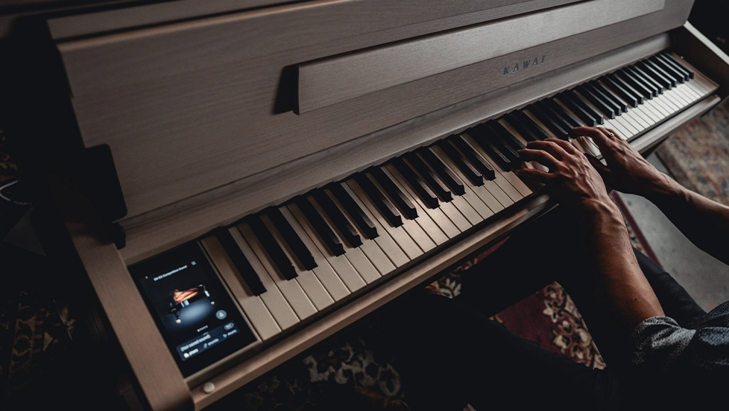 Overhead view of a person's arms playing the CA901 digital piano